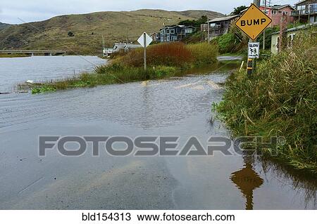 Stock Image - Traffic sign on flooded road. Fotosearch