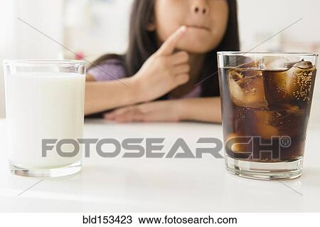 Vietnamese girl choosing between glass of soda and milk View Large Photo Image Stock Image - Vietnamese girl choosing between glass of soda and milk. Fotosearch
