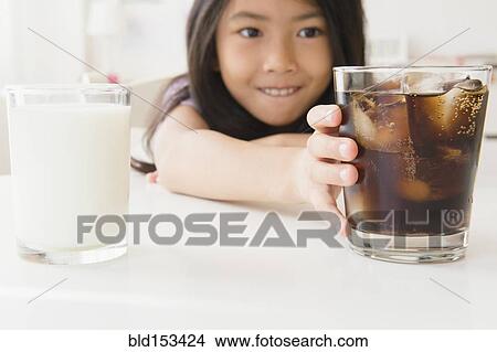 Picture - Vietnamese girl choosing glass of soda. Fotosearch