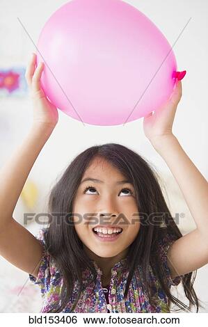 Vietnamese girl holding pink balloon View Large Photo Image Stock Photograph - Vietnamese girl holding pink balloon. Fotosearch