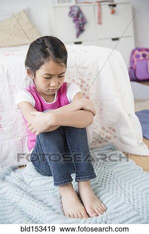 Stock Photo - Vietnamese girl pouting in bedroom. Fotosearch