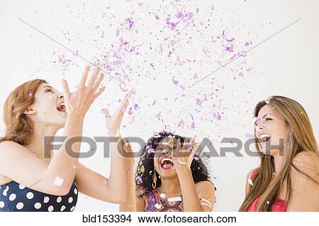 Women celebrating with confetti View Large Photo Image Picture - Women celebrating with confetti. Fotosearch