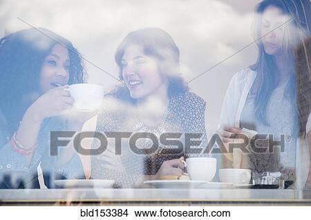 Women drinking coffee in cafe View Large Photo Image Picture - Women drinking coffee in cafe. Fotosearch