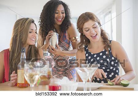 Women making cocktails in kitchen View Large Photo Image Stock Image - Women making cocktails in kitchen. Fotosearch