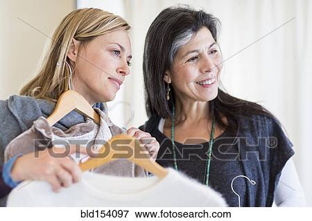 Stock Photo - Women shopping in clothing store. Fotosearch