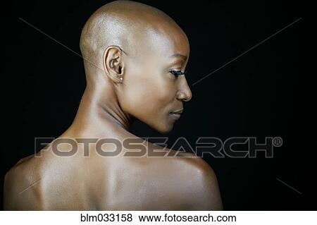 Stock Photo - African American woman looking over her shoulder. Fotosearch
