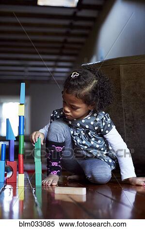 Close up of mixed race girl stacking wooden blocks View Large Photo Image Stock Photography - Close up of mixed race girl stacking wooden blocks. Fotosearch