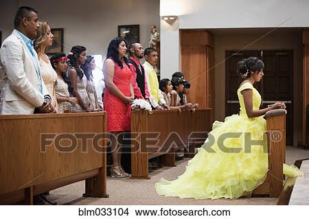 Picture - Hispanic community celebrating quinceanera in Catholic church. Fotosearch