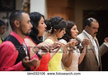 Stock Photograph - Hispanic community celebrating quinceanera in Catholic church. Fotosearch