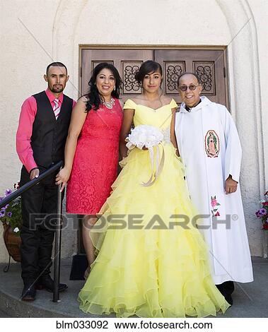 Hispanic family celebrating quinceanera with priest outside Catholic church View Large Photo Image Stock Image - Hispanic family celebrating quinceanera with priest outside Catholic church. Fotosearch