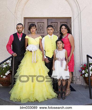 Stock Photo - Hispanic family celebrating quinceanera outside Catholic church. Fotosearch