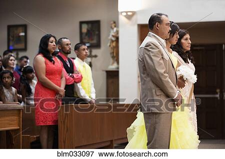 Stock Photo - Hispanic family celebrating quinceanera in Catholic church. Fotosearch