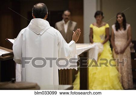 Hispanic family celebrating quinceanera with priest in Catholic church View Large Photo Image Stock Photo - Hispanic family celebrating quinceanera with priest in Catholic church. Fotosearch