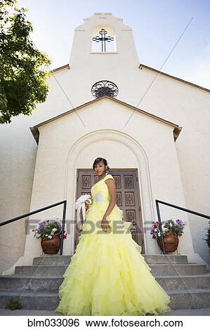 Stock Photograph - Hispanic girl celebrating quinceanera outside Catholic church. Fotosearch