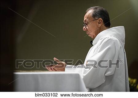 Hispanic priest giving sermon in Catholic church View Large Photo Image Stock Image - Hispanic priest giving sermon in Catholic church. Fotosearch