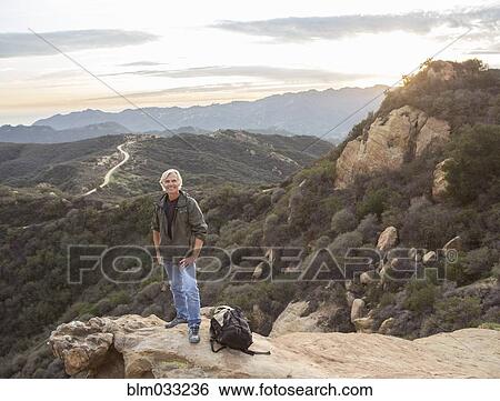 Older Caucasian man standing on rocky hilltop View Large Photo Image Stock Photograph - Older Caucasian man standing on rocky hilltop. Fotosearch