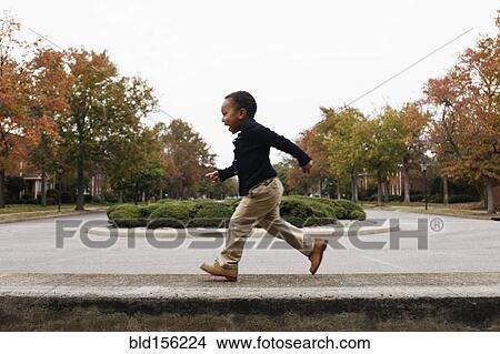 African American boy playing on suburban street View Large Photo Image Picture - African American boy playing on suburban street. Fotosearch