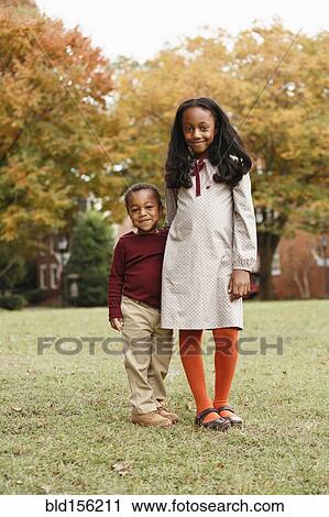 African American brother and sister smiling in park View Large Photo Image Stock Image - African American brother and sister smiling in park. Fotosearch