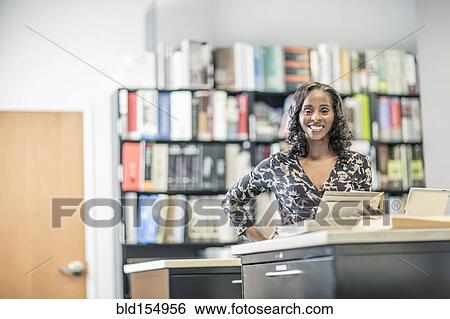 Stock Photograph - African American businesswoman working in office. Fotosearch