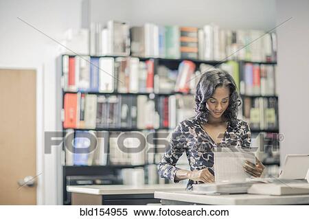 Stock Photography - African American businesswoman working in office. Fotosearch
