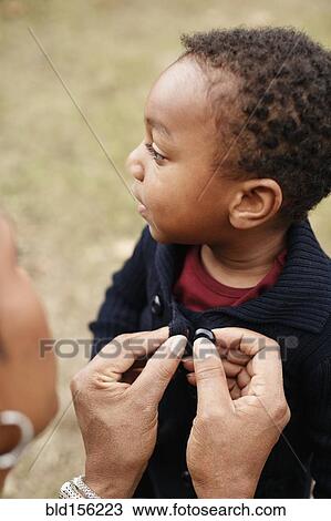 African American mother buttoning sweater of son View Large Photo Image Stock Image - African American mother buttoning sweater of son. Fotosearch
