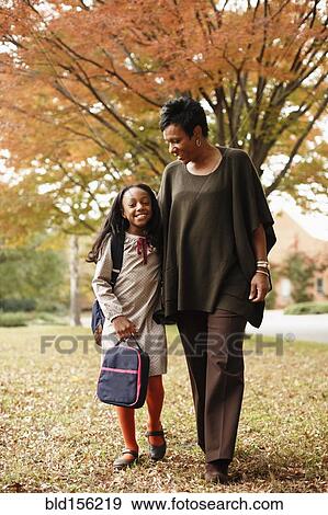 African American mother walking with daughter in park View Large Photo Image Stock Photo - African American mother walking with daughter in park. Fotosearch