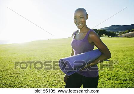 African American woman carrying yoga mat in park View Large Photo Image Stock Photography - African American woman carrying yoga mat in park. Fotosearch