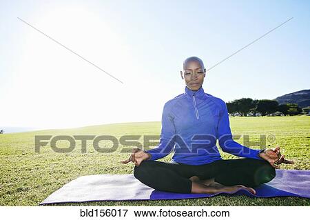 African American woman meditating in park View Large Photo Image Stock Photo - African American woman meditating in park. Fotosearch