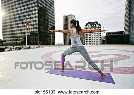 African American woman practicing yoga on urban rooftop View Large Photo Image Stock Image - African American woman practicing yoga on urban rooftop. Fotosearch