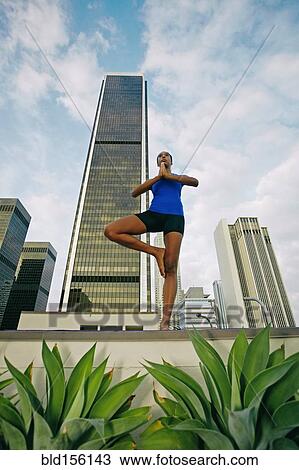 African American woman practicing yoga on urban rooftop View Large Photo Image Stock Image - African American woman practicing yoga on urban rooftop. Fotosearch