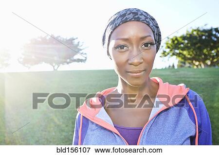 Stock Photo - African American woman smiling in park. Fotosearch
