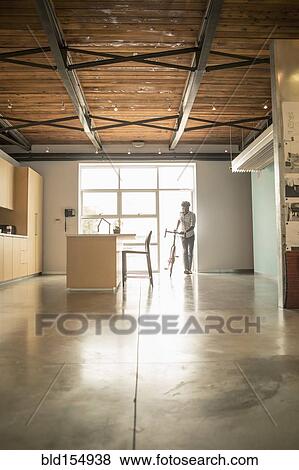 Black businessman with bicycle in office kitchen View Large Photo Image Stock Photo - Black businessman with bicycle in office kitchen. Fotosearch