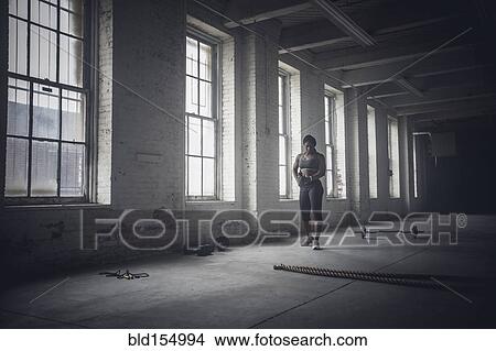 Black woman standing in dark gym View Large Photo Image Picture - Black woman standing in dark gym. Fotosearch