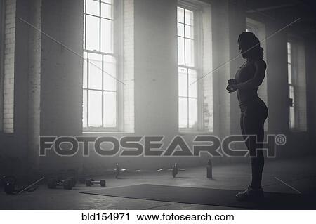 Black woman standing in dark gym View Large Photo Image Stock Image - Black woman standing in dark gym. Fotosearch