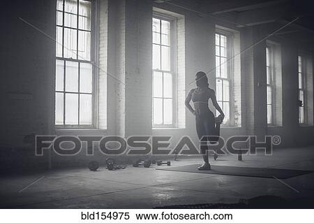 Black woman stretching in dark gym View Large Photo Image Stock Photography - Black woman stretching in dark gym. Fotosearch