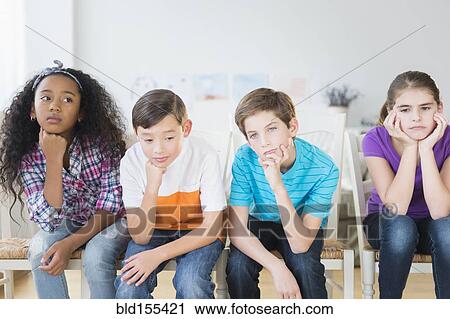 Bored children resting chins in hands View Large Photo Image Stock Image - Bored children resting chins in hands. Fotosearch