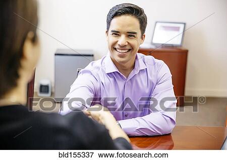Stock Photo - Business people shaking hands in office. Fotosearch