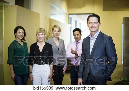 Stock Photo - Business people smiling in office lobby. Fotosearch