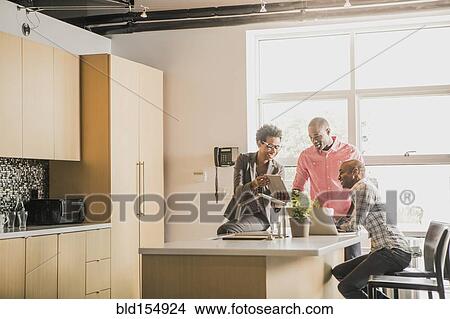 Business people talking in office kitchen View Large Photo Image Picture - Business people talking in office kitchen. Fotosearch