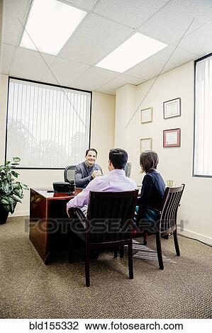 Stock Image - Business people talking in office. Fotosearch