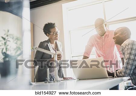 Stock Photo - Business people talking in office kitchen. Fotosearch