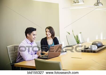 Stock Photo - Business people talking in office meeting. Fotosearch