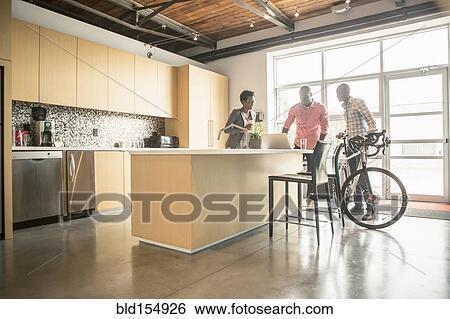 Stock Photograph - Business people talking in office kitchen. Fotosearch