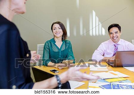Business people talking in office meeting View Large Photo Image Stock Photograph - Business people talking in office meeting. Fotosearch