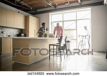 Stock Photography - Business people talking in office kitchen. Fotosearch