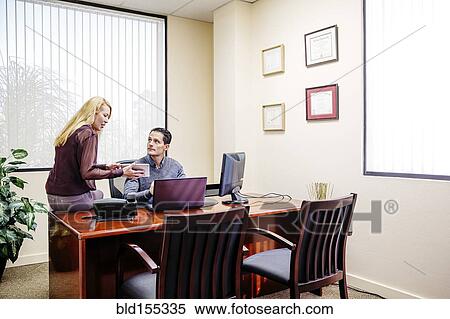 Stock Photography - Business people talking in office. Fotosearch