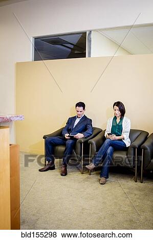Stock Photo - Business people waiting in office lobby. Fotosearch
