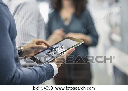 Businessman using digital tablet in office View Large Photo Image Stock Image - Businessman using digital tablet in office. Fotosearch