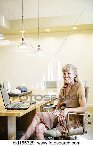 Stock Photo - Businesswoman smiling in conference room. Fotosearch