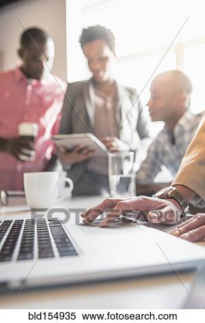 Stock Photography - Businesswoman using laptop in office. Fotosearch